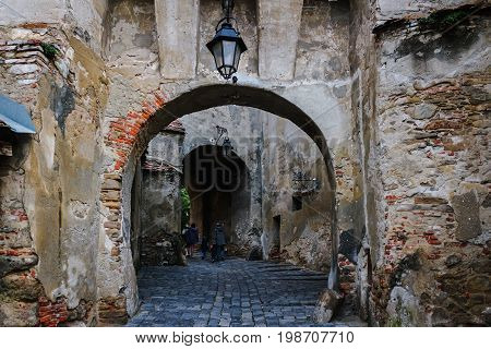 Ancient medieval stone archway in the fortress at Sighisoara town in Romania.