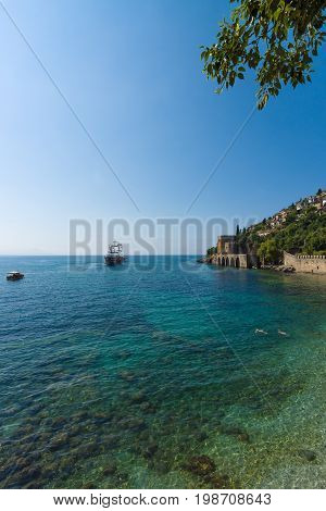 ALANYA TURKEY - JULY 04 2015: Shipyard (Tersane) and the ruins of a medieval fortress (Alanya Castle) on the mountainside.