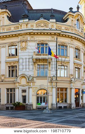Facade of City Hall in baroque style and Catholic Church tower on Large square Huet in Sibiu city Romania.