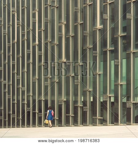 Seoul - July 2017: Students walking by glass wall of campus complex at Ewha Womans University.