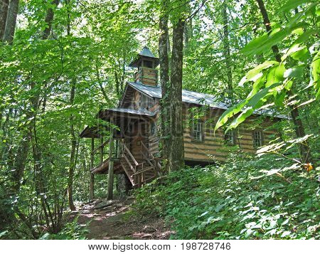 an old log church found on a hill deep in the woods
