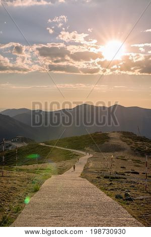 Hikers walking on a mountain at sunset in Navacerrada Madrid. Spain