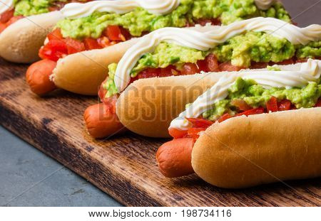 Chilean Completo Italiano. Hot Dog Sandwiches With Tomato, Avocado And Mayonnaise On Wooden Board. C
