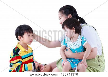 Asian mother with two children cute daughter sitting on lap. Son feel bad and sadden mom comforting. Great parenting image. Problems in the family. Isolated on white background. Studio shot.