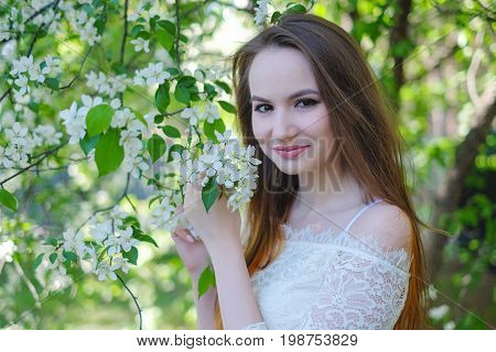 Beautiful woman in the garden of apple
