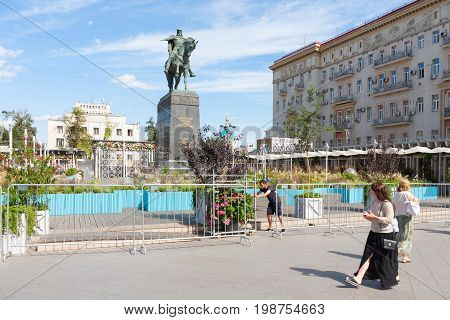 MOSCOW - AUGUST 7: Women gardener Yuri Dolgoruky monument and flower beds in Tverskaya Square on August 7 2017 in Moscow. Flower beds were installed during 