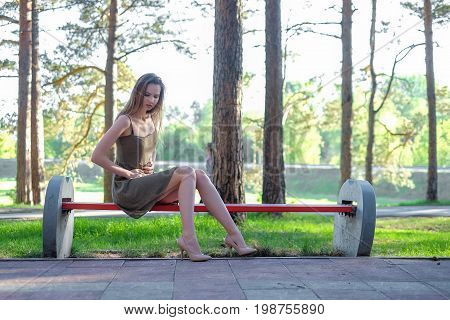 Beautiful young Woman has stomachache at park