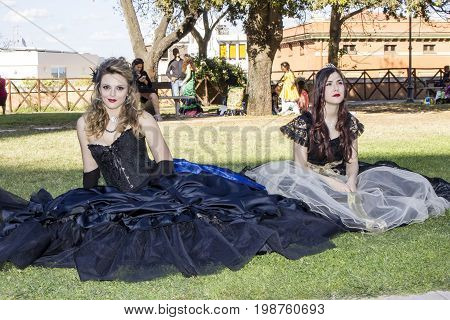 CAGLIARI ITALIA - MAY 29 2016: Sunday at the Great Jatte VIII Ed. At the Public Gardens - portrait of beautiful women wearing a Victorian-style costume - Sardinia