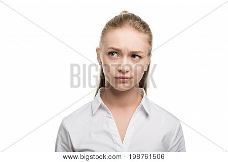 Head And Shoulders Shot Of Doubtful Caucasian Teenage Girl Isolated On White