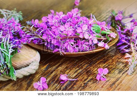 Flower Willowherb - Epilobium Angustifolium on wooden background .