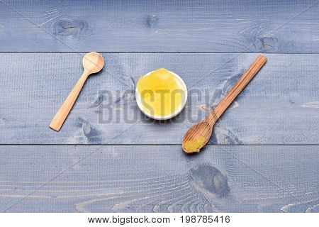 Cup Of Honey On Blue Vintage Background, Top View