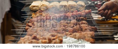 preparation of a shish kebab at an outdoor cafe