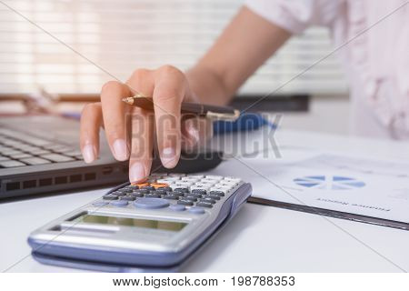 Businesswoman calculate about cost and doing finance at home office Finance managers taskConcept business and finance investment