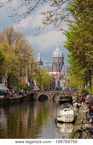 Boats and traditional houses of cannal street in autumn Amsterdam Netherlands