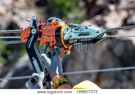 Ukraine Migea - July 30 2017: Automatic brake unit Head Rush Zip Stop for high-speed lines Zipline and for trolley lines. Equipment for safe trolling on a steel cable. Roller for high-speed zipline.