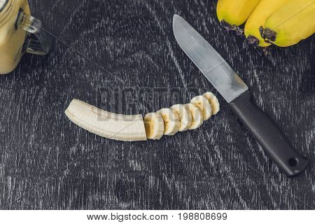 Banana Smoothies And Bananas On An Old Wooden Background