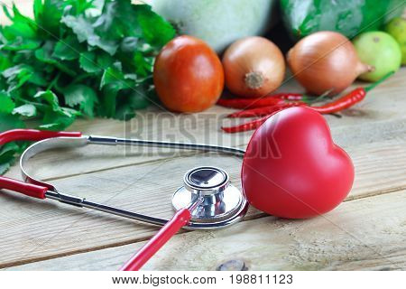 Healthy hearth concept ear doctor with herb leaf and vetgetable on wood background