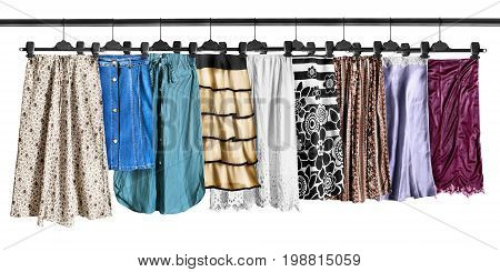 Set of midi skirts hanging on clothes racks isolated over white