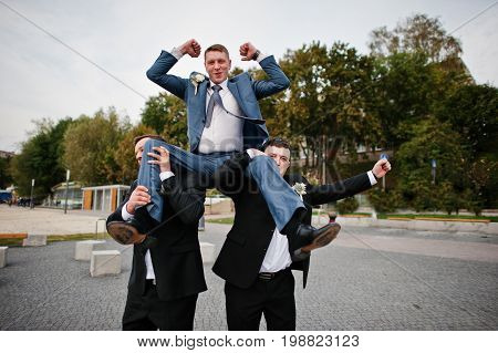 Groom With His Groomsmen Going Wild On His Wedding Day On The Lakeside.