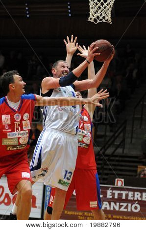 KAPOSVAR, HUNGARY - APRIL 16: Laszlo Orosz (in white) in action at a Hugarian Champonship basketball game Kaposvar vs. Nyiregyhaza April 16, 2010 in Kaposvar, Hungary.