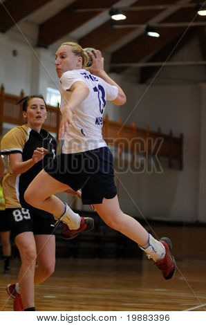 KAPOSVAR, HUNGARY - MAY 9: Zsuzsanna Csonde (in white) in action at Hungarian Handball National Championship II. match (Kaposvar vs. Bacsbokod) May 9, 2010 in Kaposvar, Hungary.