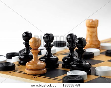The chess pieces and checkers placed on the chessboard. White background