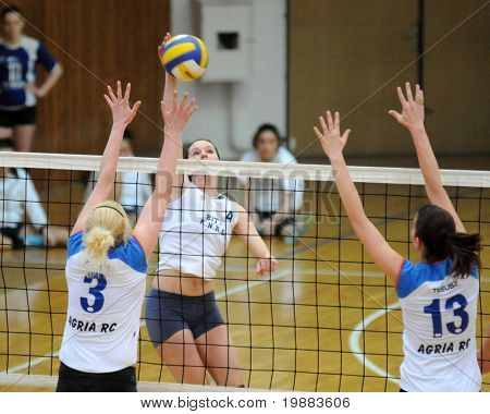 KAPOSVAR, HUNGARY - MARCH 21: Zsuzsanna Czmerk (4) strikes the ball at the Hungarian NB I. League woman volleyball game Kaposvar vs. Eger, March 21, 2010 in Kaposvar, Hungary.