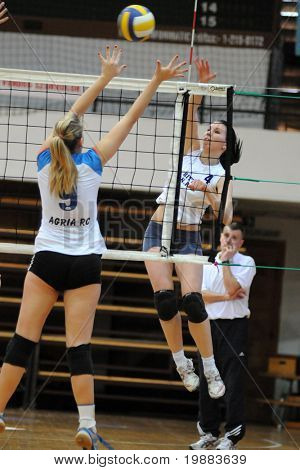 KAPOSVAR, HUNGARY - MARCH 21: Zsuzsanna Czmerk (R) strikes the ball at the Hungarian NB I. League woman volleyball game Kaposvar vs. Eger, March 21, 2010 in Kaposvar, Hungary.