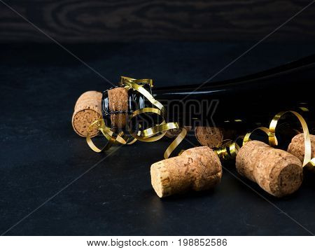 Wine Bottle On Wood Floor And Grunge Background, Nearby Cork, Tinsel, The Concept Of The Celebration