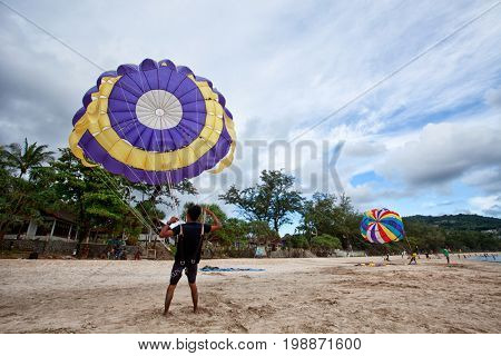 PHUKET â JULY 28, 2017, THAILAND : Parasailing at Patong Beach in Phuket. Thailand extreme sport