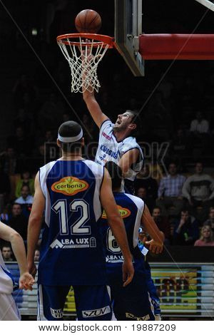 KAPOSVAR, HUNGARY - FEBRUARY 7: Laszlo Orosz (in white) in action at a Hugarian Cup basketball game Kaposvar vs. Albacomp February 7, 2007 in Kaposvar, Hungary.