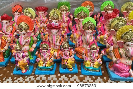Many hand crafted Ganesha idol statues displayed in a shop during Ganesh Festival.