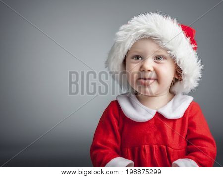 portrait of cute female caucasian child with santa claus clothes
