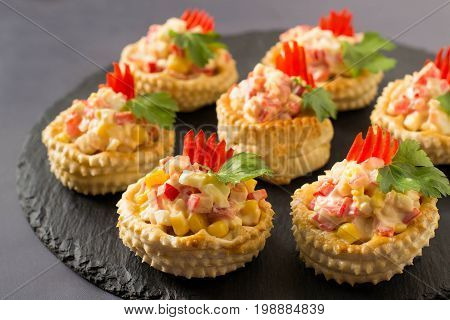 Vol-au-vent with chicken salad sweet pepper egg and corn. Festive appetizer for Christmas Valentine's Day Easter. Colorful snack of French cuisine from puff pastry with filling. Selective focus