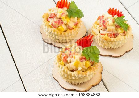 Vol-au-vent filled with chicken salad sweet pepper egg and corn. Festive appetizer for Christmas Valentine's Day Easter. Colorful snack of French cuisine from air puff pastry with filling