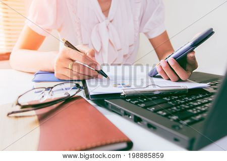 Businesswoman calculate about cost and doing finance at home office Finance managers taskConcept business and finance investment
