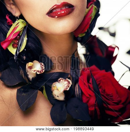 pretty brunette woman with rose jewelry, black and red, bright make up kike a vampire closeup red lips, halloween concept