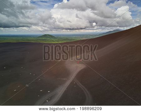 Cerro volcano in Nicaragua. People after sliding board on volcano aerial drone view