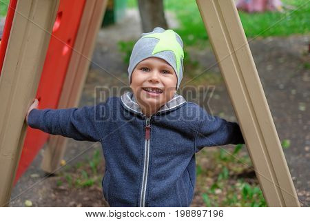 Closeup portrait of beautiful little boy on background summer park outdoor