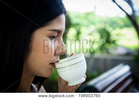 Close Up Young Woman Drinking Coffee Mug  On Break Time. Head Shot, Side View. Caucasian Girl Holdin
