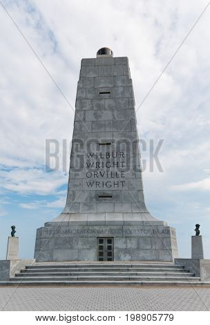 KILL DEVIL HILLS, NORTH CAROLINA - JULY 14, 2017:  The 60-foot granite monument commemorating the achievement in flight of Wilbur and Orville Wright, with sculptures of each brother.