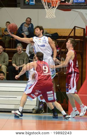 KAPOSVAR, HUNGARY - DECEMBER 11: Dan Werner (in white) in action at a Hungarian Championship basketball game Kaposvar vs. Salgotarjan December 11, 2010 in Kaposvar, Hungary.