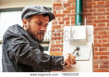 Man  Tightens A Nut