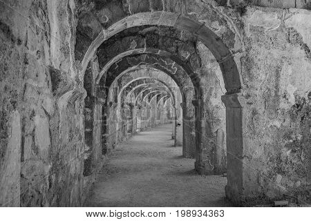 Internal passages in the ancient Roman amphitheater of Aspendos. The province of Antalya. Mediterranean coast of Turkey. Black and white. Stylization.