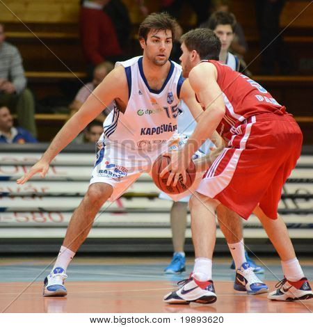 KAPOSVAR, HUNGARY - JANUARY 12: Dan Werner (in white) in action at a Hugarian Cup basketball game Kaposvar vs. Paks January 12, 2011 in Kaposvar, Hungary.