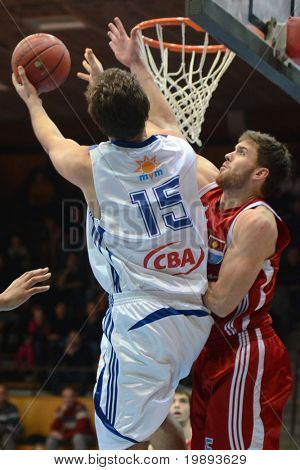 KAPOSVAR, HUNGARY - JANUARY 12: Dan Werner (in white) in action at a Hugarian Cup basketball game Kaposvar vs. Paks January 12, 2011 in Kaposvar, Hungary.