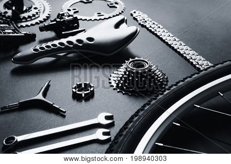 Bicycle parts and repair tools on gray background