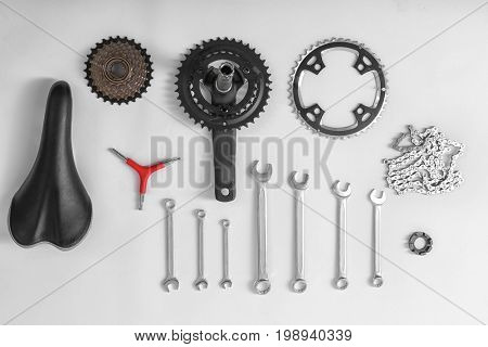 Bicycle parts and repair tools on white background