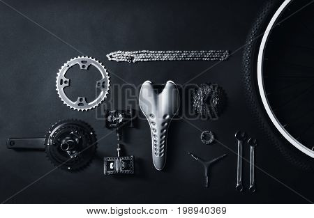 Bicycle parts and repair tools on gray background