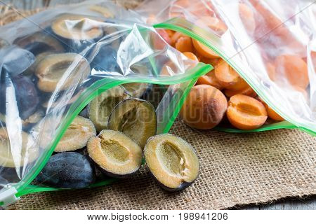 Frozen plums and apricots in a plastic bag